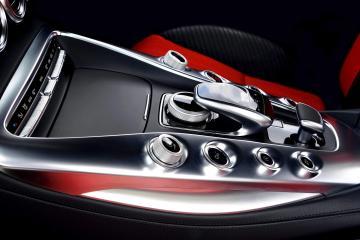 The stylish center console with aluminium elements between black and red sports auto chairs